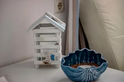 a blue bowl sitting on a table next to a toy house at Domna Studios in Líndos