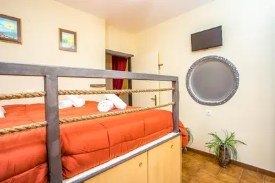 a bedroom with a bunk bed and a mirror at Takis Hotel Apartments in Ialyssos