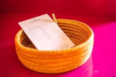 a book in a basket with a card in it at Takis Hotel Apartments in Ialyssos