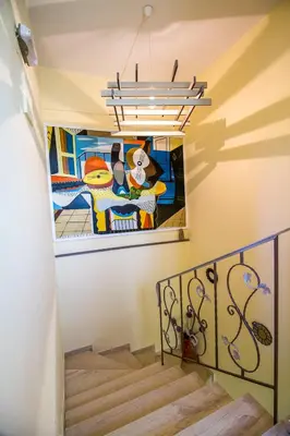 a staircase with a painting on the wall at Takis Hotel Apartments in Ialyssos