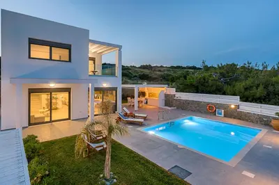 a house with a swimming pool in the backyard at Villa Sea La Vie in Kiotari