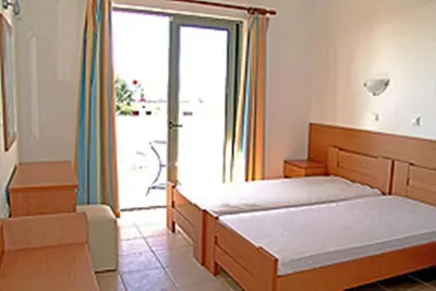 a bedroom with a bed and a large window at Apostolis studios Pefki Lindos Rhodes in Pefki Rhodes