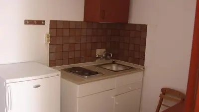a small kitchen with a sink and a small refrigerator at Apostolis studios Pefki Lindos Rhodes in Pefki Rhodes