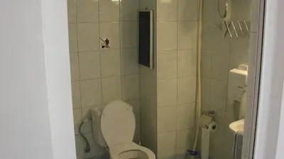 a small bathroom with a toilet and a sink at Apostolis studios Pefki Lindos Rhodes in Pefki Rhodes