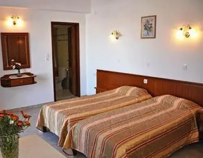 a hotel room with a bed and a bathroom at Villa Koki Studios in Líndos