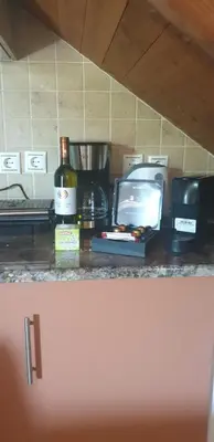 a bottle of wine and a tv on a counter at Stergios villa in Kolimbia