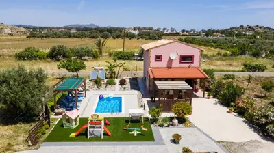 an overhead view of a backyard with a pool and a house at Stergios villa in Kolimbia