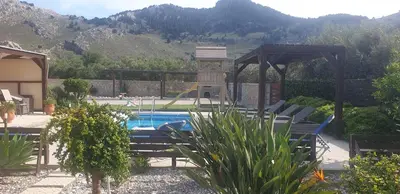 a swimming pool with chairs and a gazebo at Stergios villa in Kolimbia