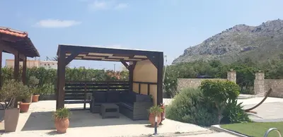 a gazebo with a couch sitting under it at Stergios villa in Kolimbia