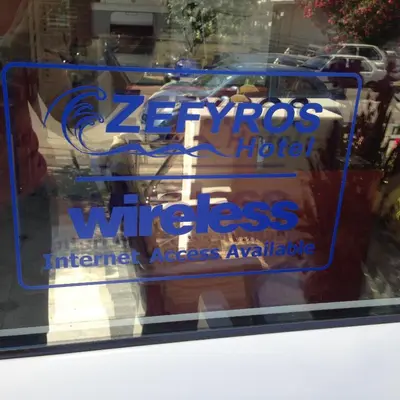 a sign on the window of a store at Zefyros Hotel in Rhodes Town