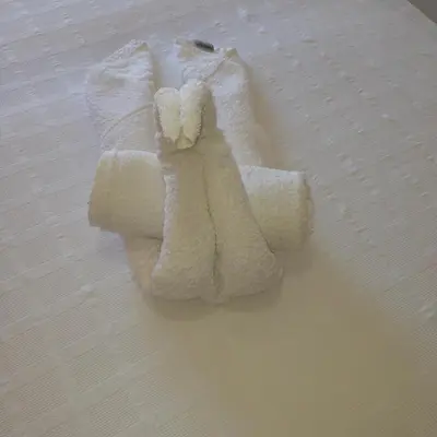 a pile of white towels sitting on a bed at Zefyros Hotel in Rhodes Town
