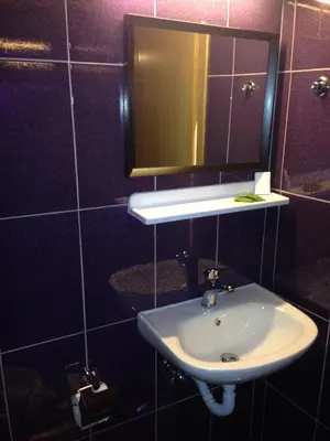 a bathroom with a sink and a mirror at Zefyros Hotel in Rhodes Town