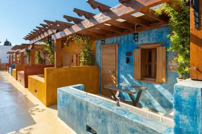 a blue building with a table on the outside at 10GR Boutique Hotel & Wine Bar in Rhodes Town