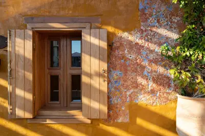 an entrance to a house with a wooden door at 10GR Boutique Hotel & Wine Bar in Rhodes Town