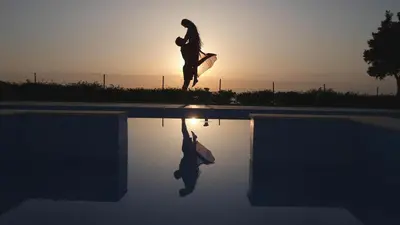 a person is jumping into a swimming pool at Monte Smith Luxury Villas in Rhodes Town