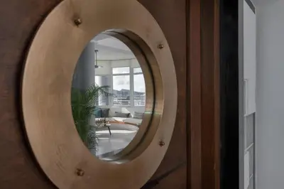 a mirror on a wooden door with a living room at Monte Smith Luxury Villas in Rhodes Town