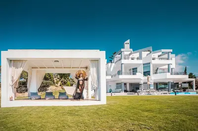 a person standing in front of a large building at Monte Smith Luxury Villas in Rhodes Town