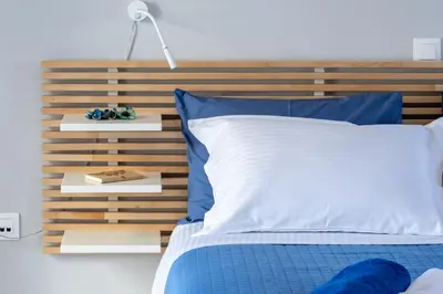 a bedroom with a wooden headboard and a blue bed at Gennadi Villa Mary in Gennadi