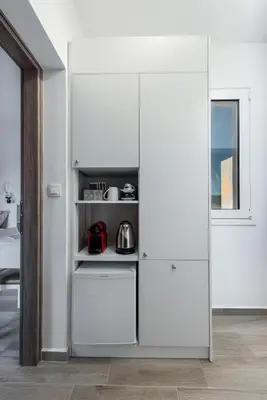 a white refrigerator in a kitchen next to a window at Gennadi Villa Mary in Gennadi