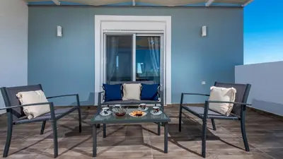 a living room with two chairs and a table at Gennadi Villa Mary in Gennadi