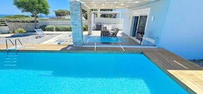 a swimming pool in front of a house at Gennadi Villa Mary in Gennadi
