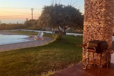 a grill outside of a house with a pool at CRISTELIA SEAFRONT & POOL VILLA in Lachania