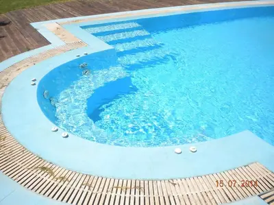 a large swimming pool with blue water in it at CRISTELIA SEAFRONT & POOL VILLA in Lachania