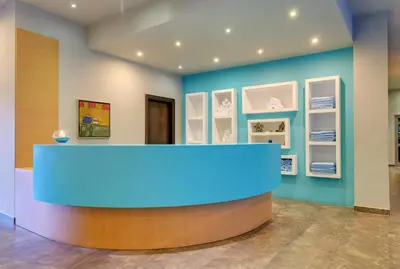 a blue counter in a room with pictures on the wall at Apollo Blue in Faliraki