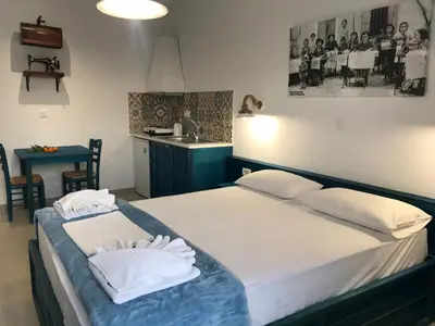 a bedroom with a bed with two white pillows at Filoxenia Apartments & Studios in Theologos