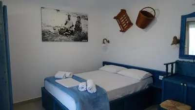 a bedroom with a bed with towels on it at Filoxenia Apartments & Studios in Theologos