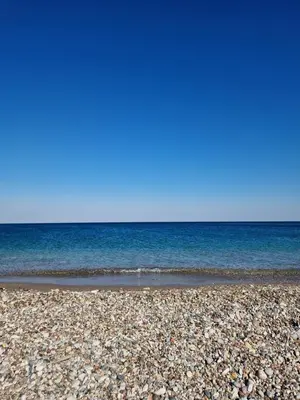 a rocky beach with the ocean in the background at Eleftherias Garden House in Afantou