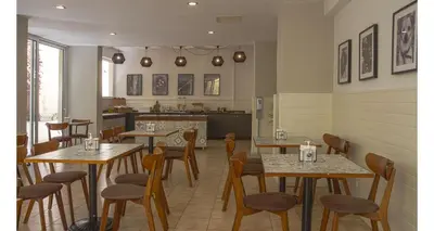 a row of tables and chairs in a restaurant at Majestic Hotel - Adults Only in Rhodes Town