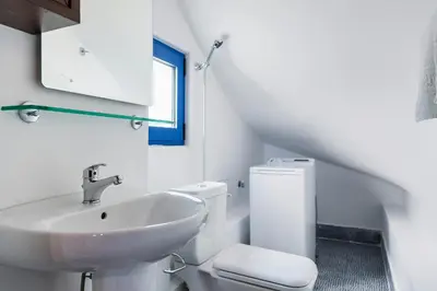 a white bathroom with a sink and a toilet at Lianas Garden House in Rhodes Town