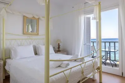 a bedroom with a bed with a view of the ocean at Uno Luxury Apartment with Sea view in Livadia