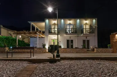a white house with a street light in front of it at Uno Luxury Apartment with Sea view in Livadia