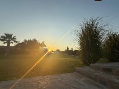 a road with the sun setting in the distance at Villa Rizia in Kolimbia