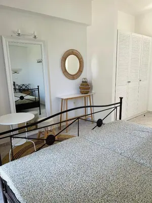a bedroom with a bed and a mirror at Villa Rizia in Kolimbia