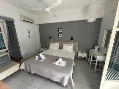 a bedroom with two beds with towels on them at George Apartments in Livadia