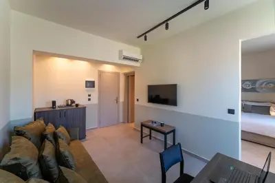 a living room with a couch and a bed at Mariette Rhodes Urban Suites in Rhodes Town