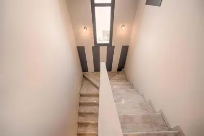 a staircase in a room with a window and a stair case at Villa Pandesia in Kremasti