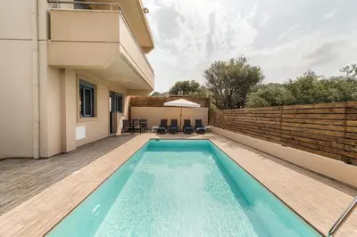 a swimming pool in the backyard of a house at Villa Pandesia in Kremasti