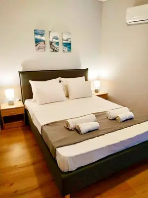 a bedroom with a large bed with two towels on it at Emerald Dream House,Heart of the City Center in Rhodes Town