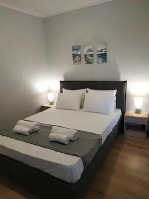 a bedroom with a large bed with two pillows at Emerald Dream House,Heart of the City Center in Rhodes Town