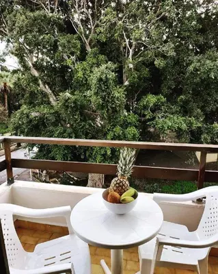 a table and chairs with a bowl of fruit on it at Emerald Dream House,Heart of the City Center in Rhodes Town