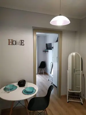 a room with a table and chairs and a refrigerator at Emerald Dream House,Heart of the City Center in Rhodes Town
