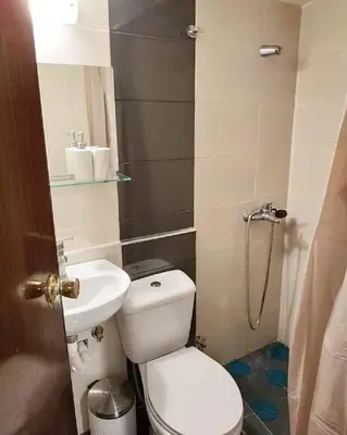 a small bathroom with a toilet and a sink at Emerald Dream House,Heart of the City Center in Rhodes Town