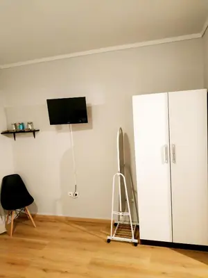 a room with a white cabinet and a tv on a wall at Emerald Dream House,Heart of the City Center in Rhodes Town