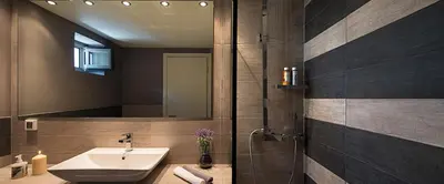 a bathroom with a sink and a shower with a mirror at Villa Kalypso in Halki