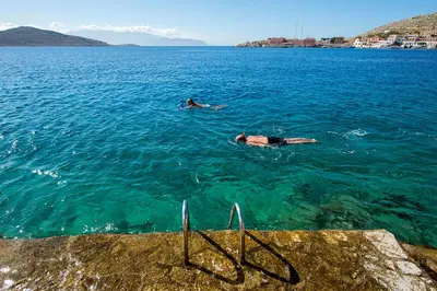 two people swimming in a large body of water at Villa Kalypso in Halki