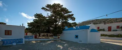 a small white building with a tree in the background at Villa Kalypso in Halki